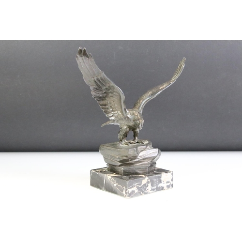 149 - Bronze effect Metal Eagle on a Rock mounted on a marble base, 24cm high together with a Brass Model ... 