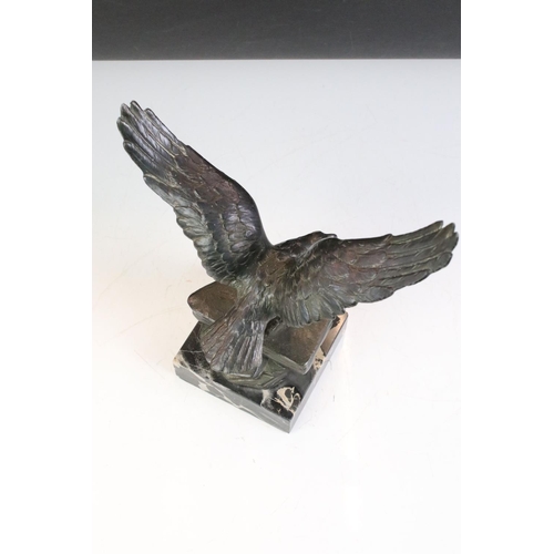 149 - Bronze effect Metal Eagle on a Rock mounted on a marble base, 24cm high together with a Brass Model ... 