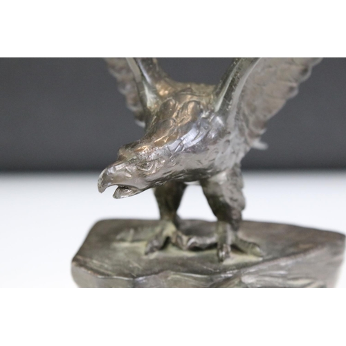 149 - Bronze effect Metal Eagle on a Rock mounted on a marble base, 24cm high together with a Brass Model ... 