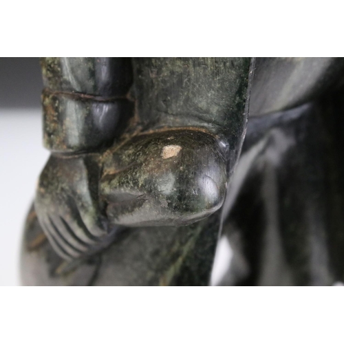 155 - Stone Carving of an Old Man with Walking Stick and a Bag, stood on a wooden plinth, 50cm high