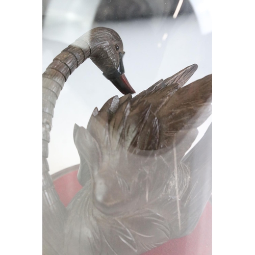 161 - Black Forest style carved Wooden Swan with articulated neck held within a glass dome cover on stand,... 