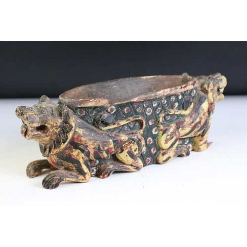 162 - South East Asian Wooden Carved Bowl support by two Lion Dogs with polychrome painted decoration, 28c... 