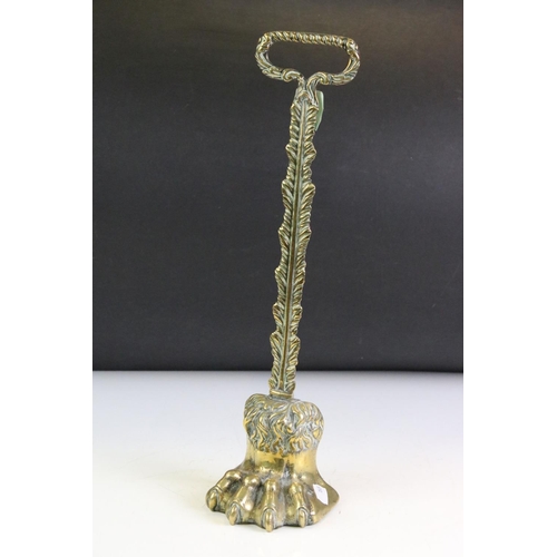 164 - 19th century Brass ' Lion Paw ' Doorstop with foliate loop handle and weighted base, 39.5cm high