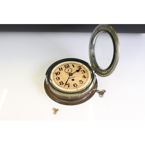 185 - Seikosha Ship's Circular Brass Bulkhead Clock, the dial with Arabic numerals, fast / slow switch and... 