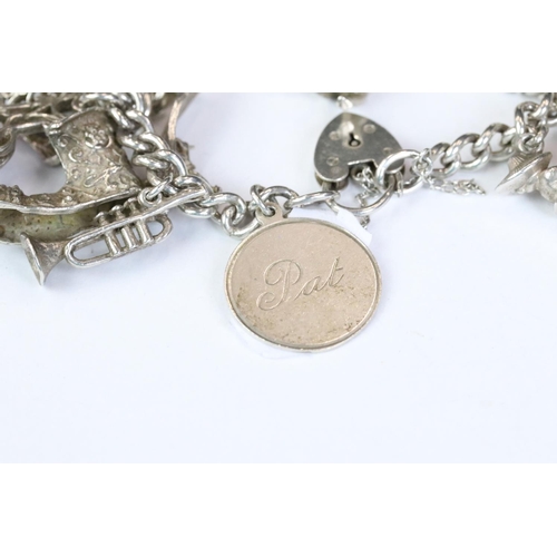 229 - A folly hallmarked sterling silver charm bracelet complete with charms.