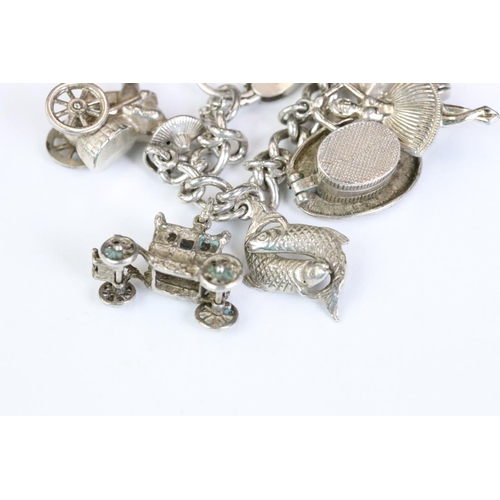 229 - A folly hallmarked sterling silver charm bracelet complete with charms.