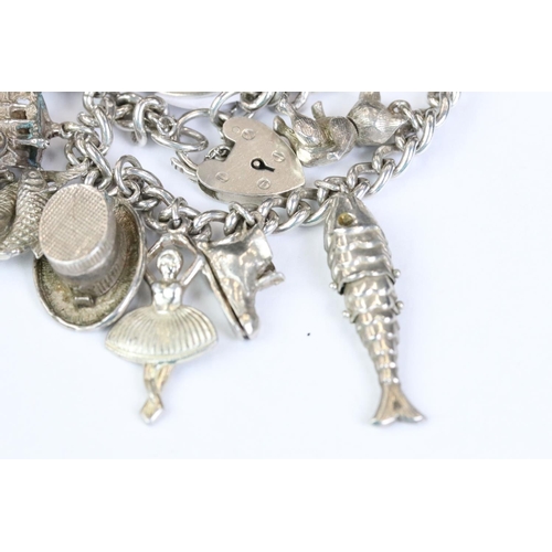 229 - A folly hallmarked sterling silver charm bracelet complete with charms.