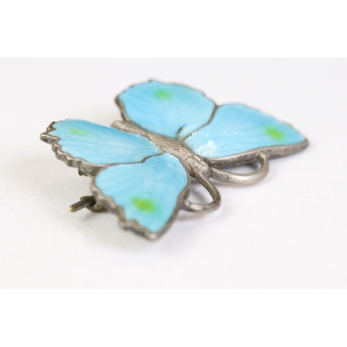 232 - A sterling silver butterfly brooch with blue enamel decoration.