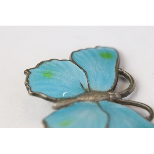 232 - A sterling silver butterfly brooch with blue enamel decoration.