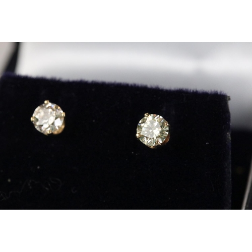 239 - Pair of 18ct white gold diamond stud earrings of 60 points