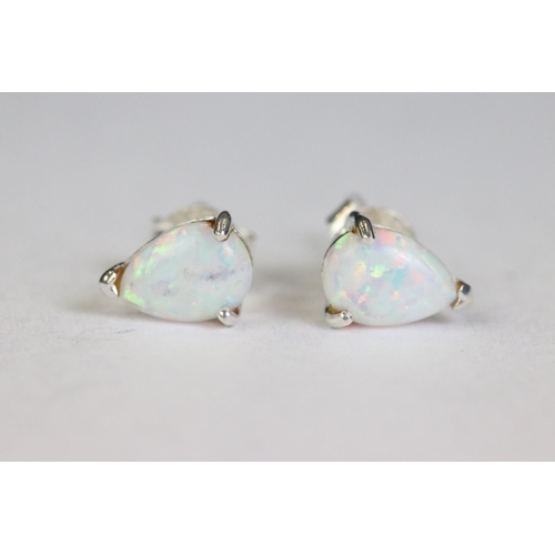 252 - Pair of silver and opal pear shaped stud earrings