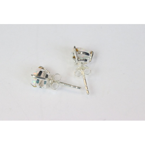 252 - Pair of silver and opal pear shaped stud earrings