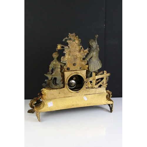 183 - An antique French gilt mantle clock with decorative ironmonger figures.