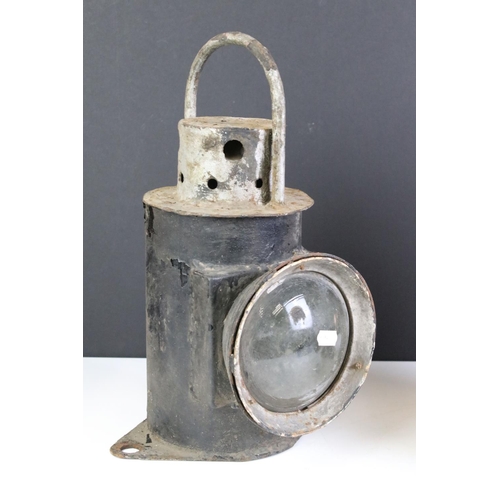 384 - Two vintage railway lanterns to include a clear and red lens example.