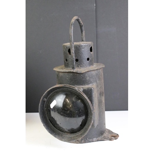 384 - Two vintage railway lanterns to include a clear and red lens example.