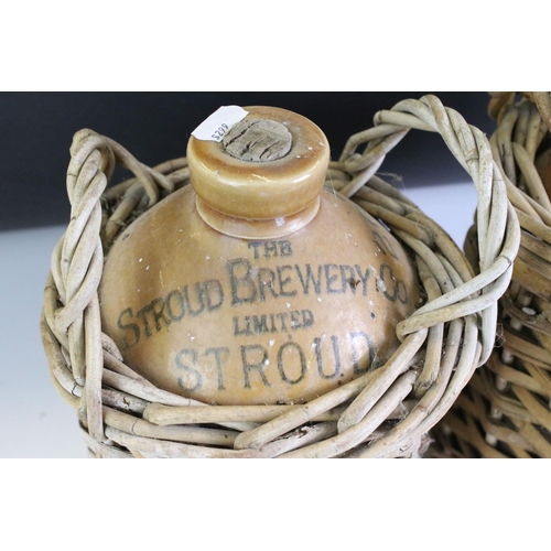 402 - A group of three stoneware bottles to include two Stroud advertising examples together with a small ... 