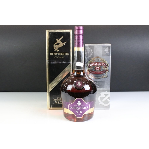 423 - A bottle of Courvoisier V.S. Cognac together with a bottle of Remy Martin V.S.O.P. and a bottle of 1... 