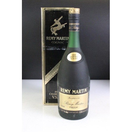 423 - A bottle of Courvoisier V.S. Cognac together with a bottle of Remy Martin V.S.O.P. and a bottle of 1... 