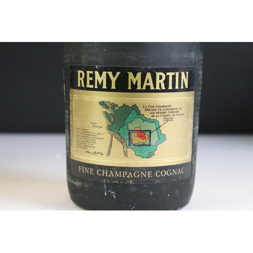 423 - A bottle of Courvoisier V.S. Cognac together with a bottle of Remy Martin V.S.O.P. and a bottle of 1... 