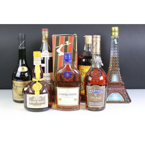 429 - A small collection of bottled alcohol to include Courvoisier, Grand Marnier and Martell.