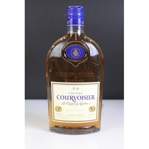 429 - A small collection of bottled alcohol to include Courvoisier, Grand Marnier and Martell.