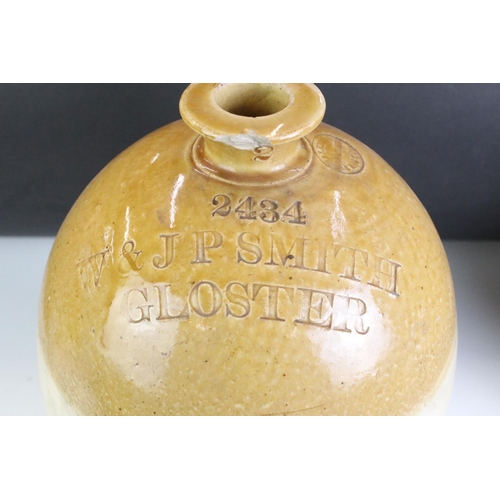 430 - A pair of vintage stoneware bottles to include a Swindon advertising example.