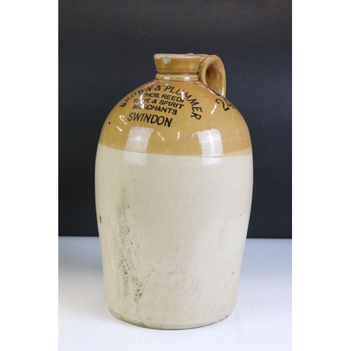 430 - A pair of vintage stoneware bottles to include a Swindon advertising example.