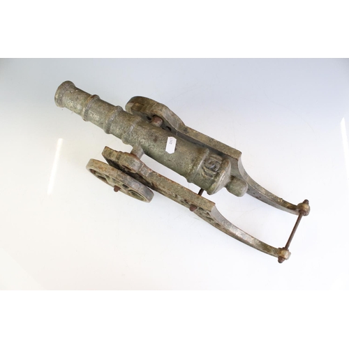 431 - Cast Metal Model of an Artillery Canon, 45cm long together with an Oak Stand carved with the initial... 