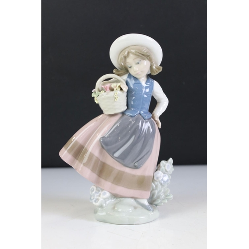 74 - Two Lladro Figures of Girls holding baskets of flowers, 18cm high together with Dartington Crystal '... 