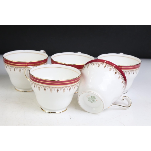 95 - Aynsley Bone China Dinner and Tea ware decorated with red deep borders and gilt highlights including... 