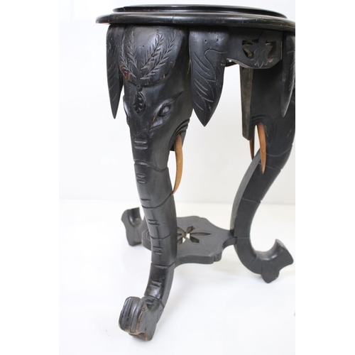 577 - Ebonised Circular Jardiniere / Plant Stand, the supports carved in the form of elephant heads, 38cm ... 