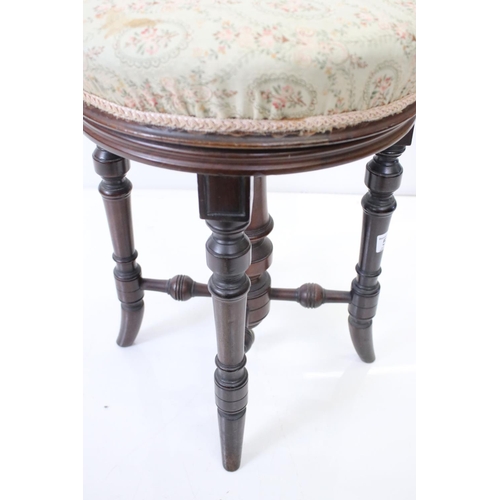 579 - Victorian Circular Adjustable Piano Stool with upholstered seat and turned supports, 36cm diameter