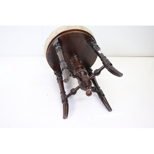 579 - Victorian Circular Adjustable Piano Stool with upholstered seat and turned supports, 36cm diameter