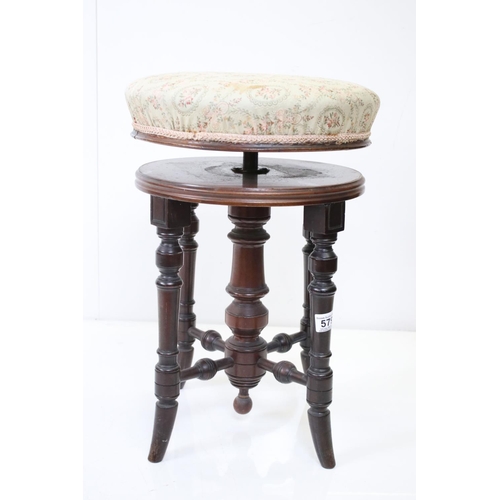 579 - Victorian Circular Adjustable Piano Stool with upholstered seat and turned supports, 36cm diameter