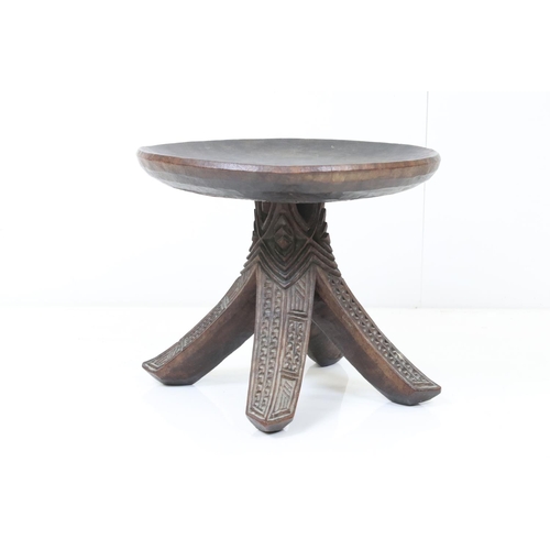 581 - Ethnic Hardwood Stool with dish seat and raised on four carved curved legs, possibly South Sea Islan... 