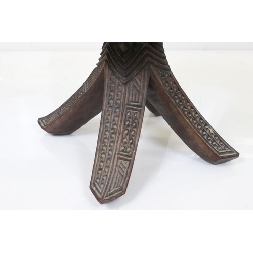 581 - Ethnic Hardwood Stool with dish seat and raised on four carved curved legs, possibly South Sea Islan... 