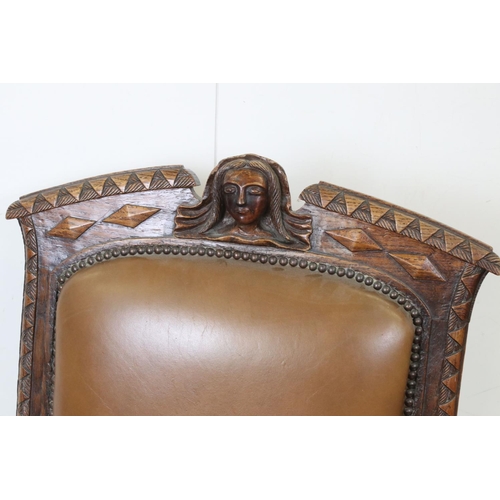 585 - Victorian Carved Oak Open Armchair, the top rail carved with a face mask, raised on castors, 66cm wi... 