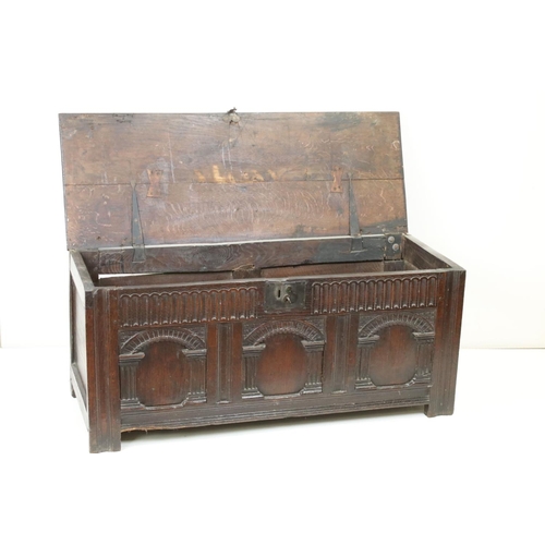 541 - 18th century Oak Coffer with carved three panel front, with key, 112cm long x 43cm deep x 49cm high