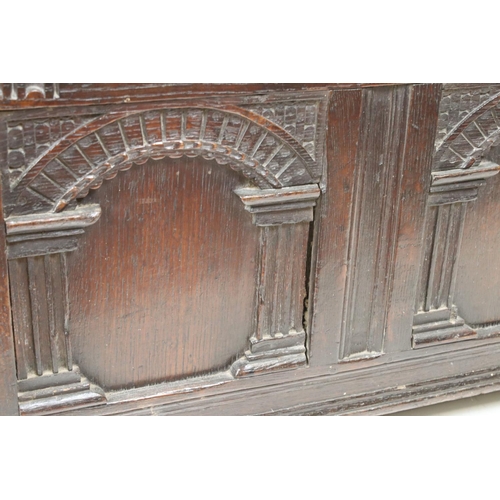 541 - 18th century Oak Coffer with carved three panel front, with key, 112cm long x 43cm deep x 49cm high