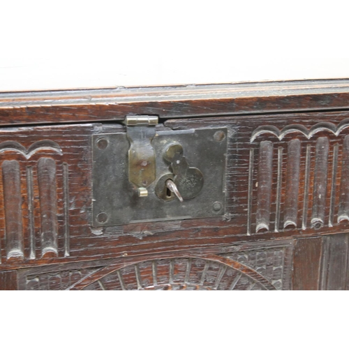 541 - 18th century Oak Coffer with carved three panel front, with key, 112cm long x 43cm deep x 49cm high