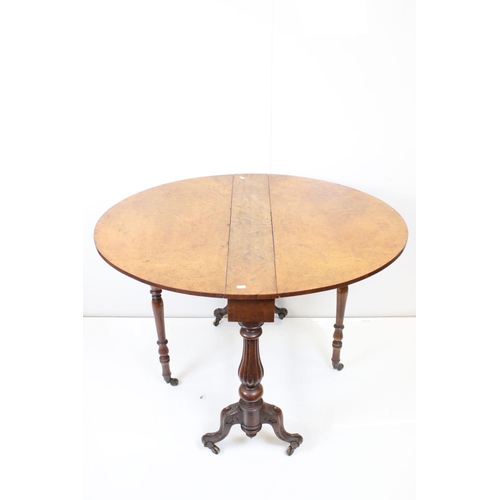 591 - Victorian Burr Walnut and Walnut Oval Sutherland Table raised on reeded bulbous supports and castors... 