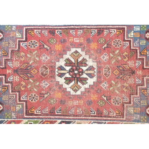 558 - Iranian Wool Red Ground Rug with stylised pattern of birds and flowers within a border, 105cm x 67cm