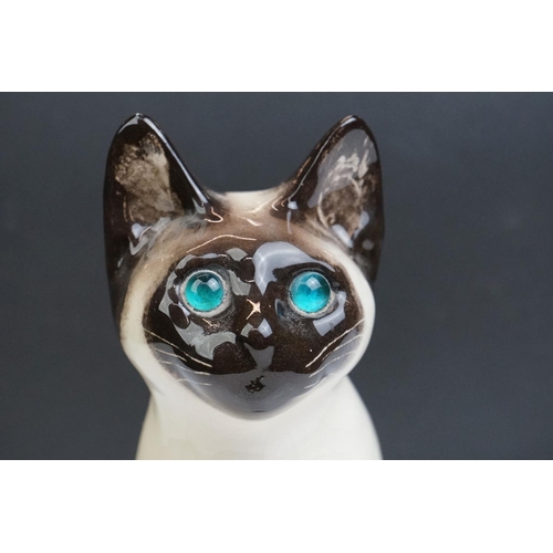 15 - Winstanley pottery figure of a seated Siamese cat, with blue glass eyes, numbered 34, signed ' Kensi... 