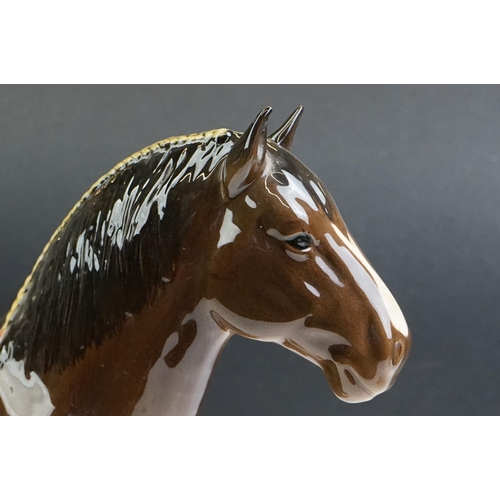 61 - Two Beswick porcelain shire horse figures in brown gloss (tallest measures 26.5cm high)