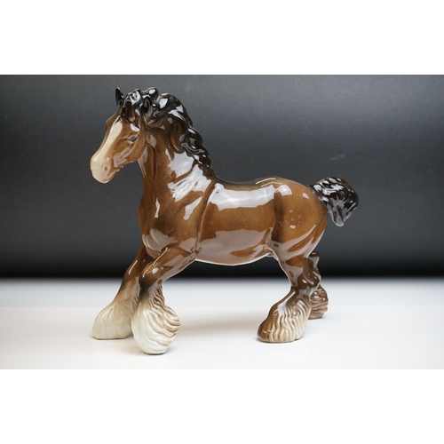 61 - Two Beswick porcelain shire horse figures in brown gloss (tallest measures 26.5cm high)