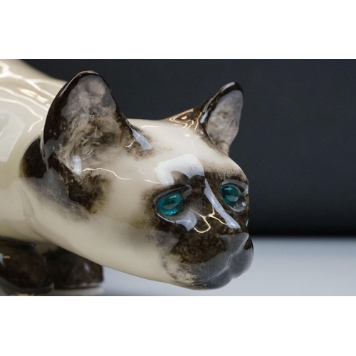 8 - Winstanley pottery figure of a crouching Siamese cat with blue glass eyes, signed to the base and nu... 