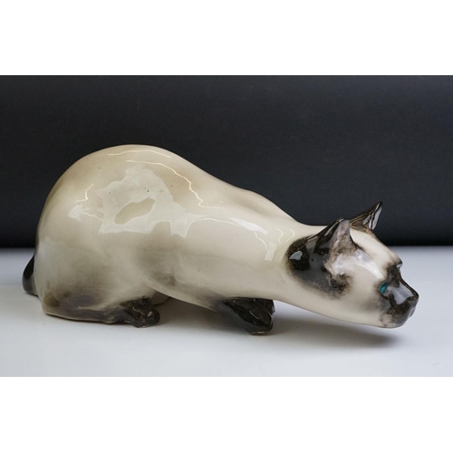 8 - Winstanley pottery figure of a crouching Siamese cat with blue glass eyes, signed to the base and nu... 