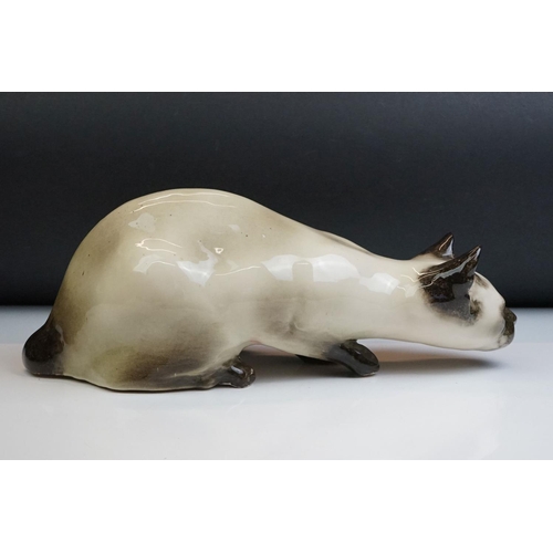 8 - Winstanley pottery figure of a crouching Siamese cat with blue glass eyes, signed to the base and nu... 