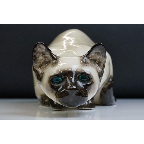 8 - Winstanley pottery figure of a crouching Siamese cat with blue glass eyes, signed to the base and nu... 