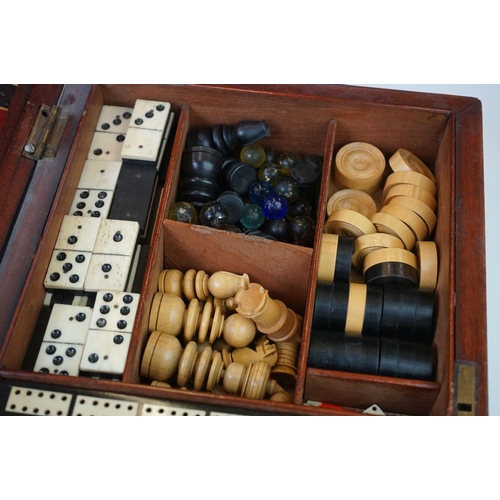 197 - An early 20th century wooden cased games compendium to include Solitaire, Cribbage, Chess....etc. Co... 